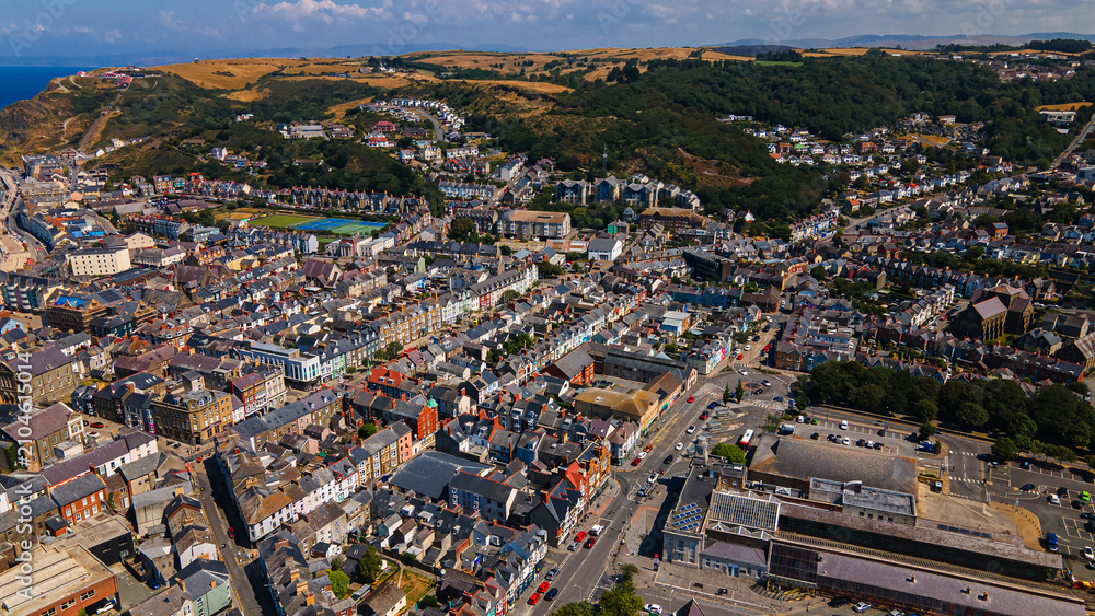 Fototapeta premium Aerial view of Aberystwyth town landscape rooftops and hill