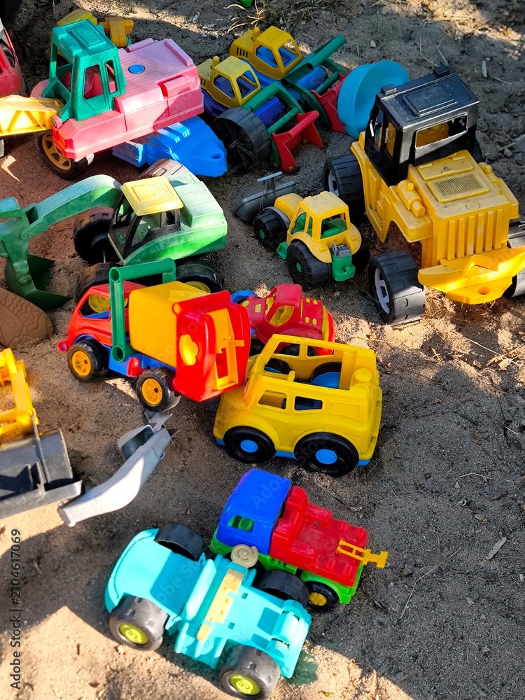 Fototapeta premium Multicolor plastic toy cars in a children's sandbox.