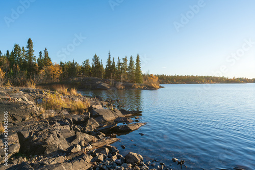 Frame Lake shore at sunset time, clear sky and sunlight. Yellowknife, Canada.