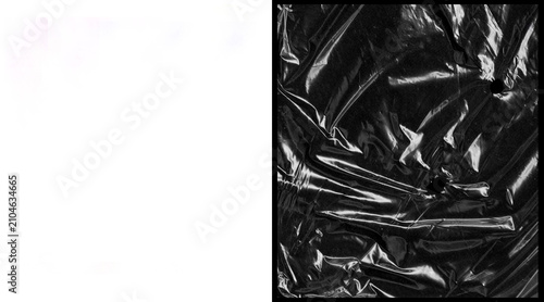 Konstfotografi Crumpled black plastic texture with glossy highlights, wrinkled polyethylene fil