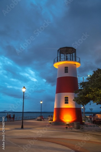 Puntarenas, Costa Rica, Lighthouse by the sea at dusk, serene atmosphere, perfect for travel and adventure.