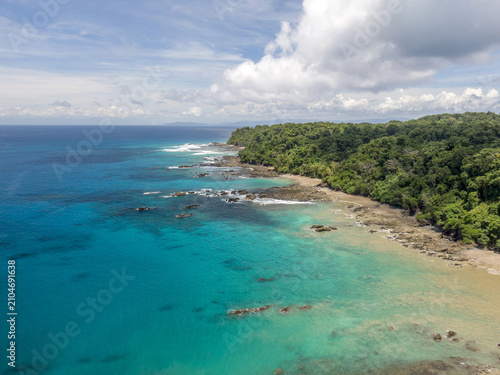 Beach with clear blue water and coral reef, tropical paradise. Caño Island, Costa Rica, national park.