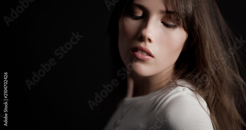 Obraz na plátně Brunette woman closing eyes and tilting head, expressing serenity and beauty