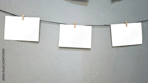 Blank Photo Prints Hanging on Rope with Wooden Clothespins Mockup Template and Copy Space Background