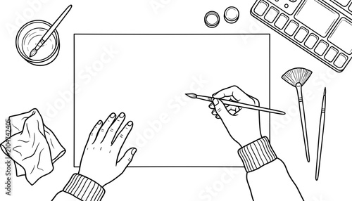 Top view of artist hands drawing on blank paper with art supplies.