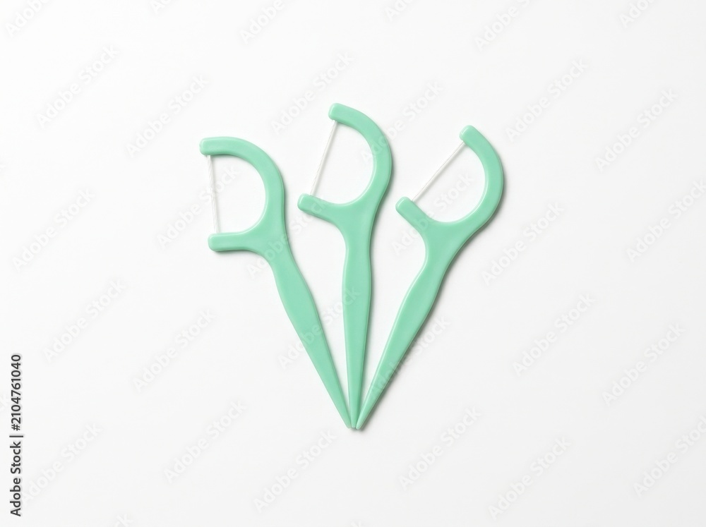 Naklejka premium Mint Green Dental Floss Picks on White Background