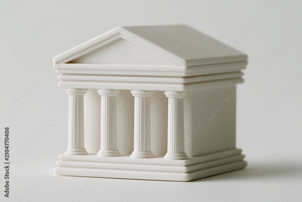 Obraz premium Miniature White Classical Building Model with Columns on a White Background