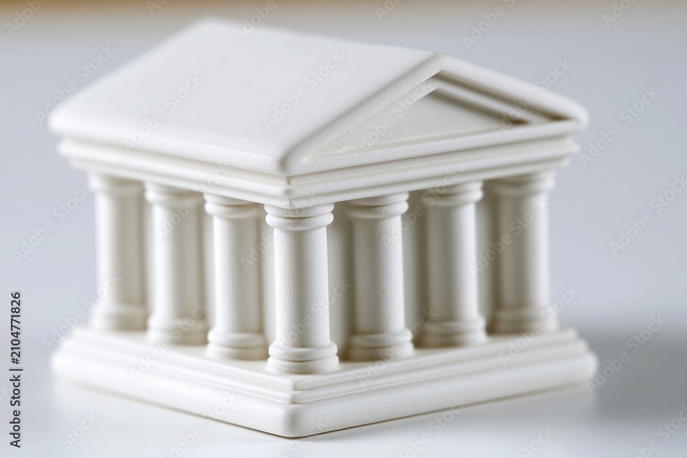 Obraz premium Miniature white neoclassical building with columns, representing architecture, law, or finance