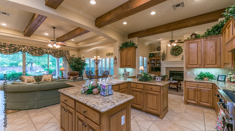Obraz premium Spacious luxury open concept kitchen and living area with natural light and decorative beams