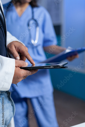 Close up of medic pointing at tablet screen for medical practice