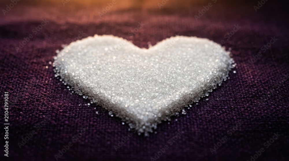 Obraz premium Sugar heart shape on purple fabric romantic valentine's day concept