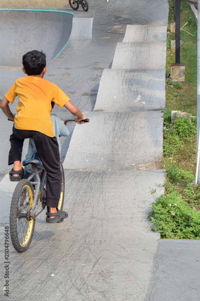 Obraz premium little boy riding a bike