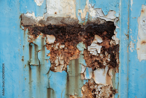 Peeling blue paint with rusted metal texture industrial background
