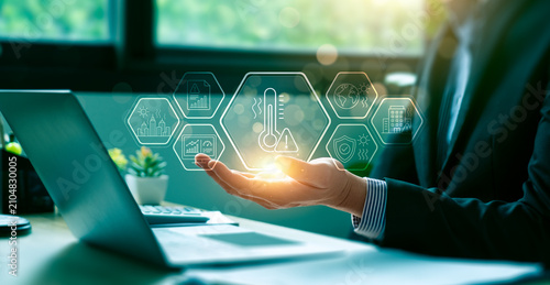 Climate risk management concept with business professional holding virtual heat warning interface showing global warming impact urban safety environmental monitoring and sustainability planning