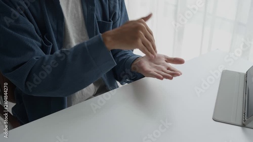 Asian man learning to using sign language