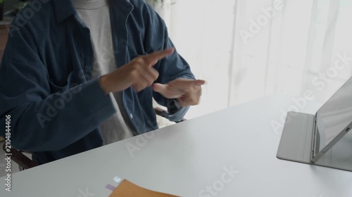 Asian man learning to using sign language