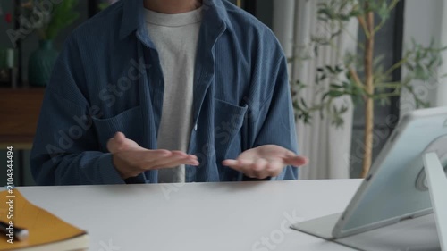 Asian man learning to using sign language