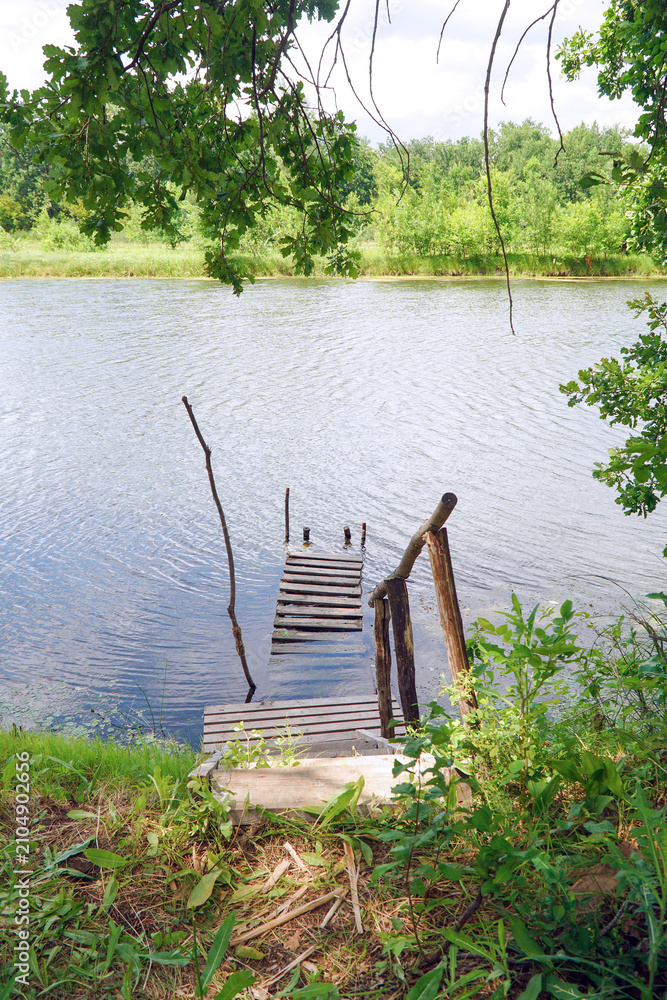 Fototapeta premium Wooden pier on a calm lake shore