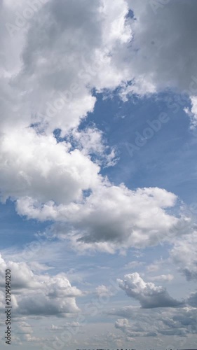 Vertical Timelapse of Dramatic Cumulus Clouds Moving Across Blue Sky