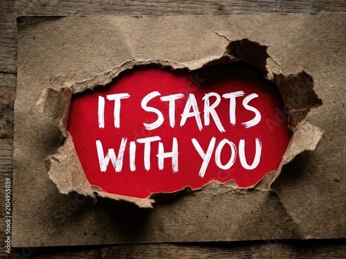 Torn paper reveals red background with white text 