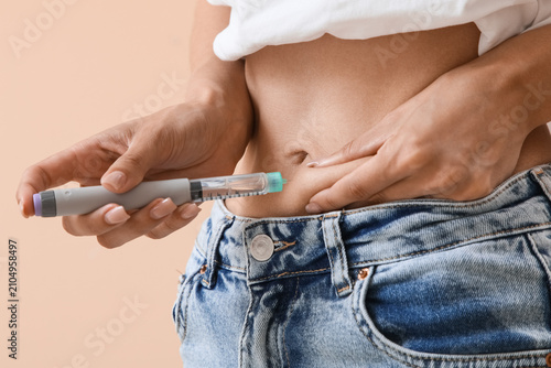 Woman injecting insulin int...