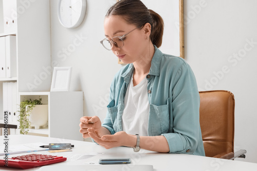 Young woman counting coins ...