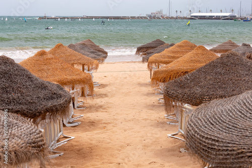 Beach umbrellas and sandy shoreline in Cascais, Portugal