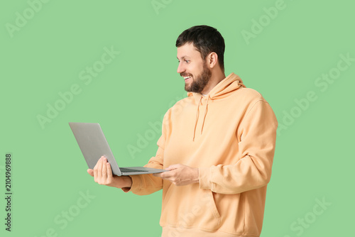 Surprised young man using l...