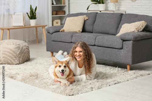 Young woman with cute Corgi...