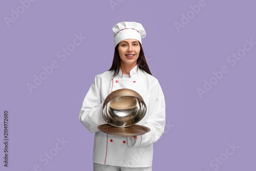 Female chef with metal tray...