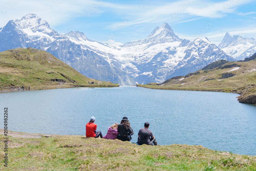 Fototapeta premium Scenic view of Bachalpsee Lake with Snow Capped Swiss Alps mountain at Grindelwald First, Switzerland. Beautiful landscape in Jungfrau Region. famous Europe summer hiking trail and travel destination