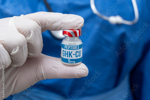 GHK-CU peptide vial held by a clinical professional for medical research
