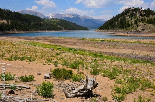 low water levels due to drought at summit cove on the snake river arm of  the dillon reservoir on a sunny summer day, looking out at the rocky mountains in dillon, colorado