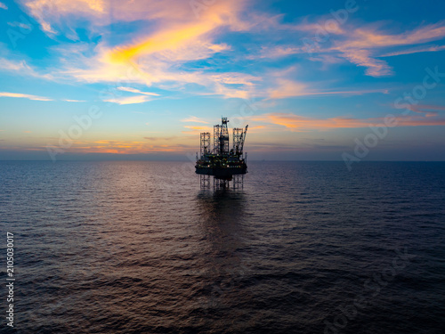 Aerial view of offshore jack up rig and offshore platform during sunset