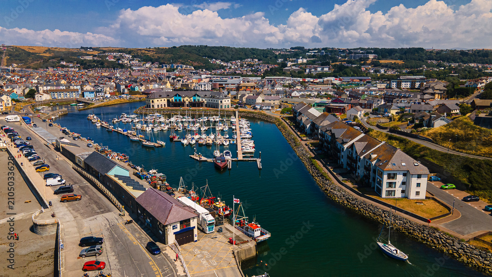 Fototapeta premium Aerial view of harbor channel marina boats and waterfront buildings