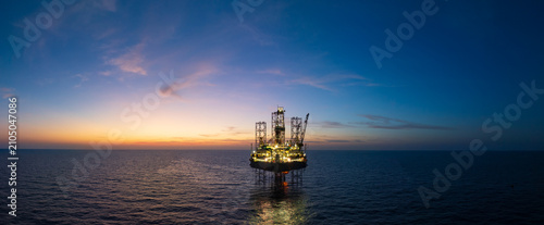 Aerial view of offshore jack up rig and offshore platform during sunset