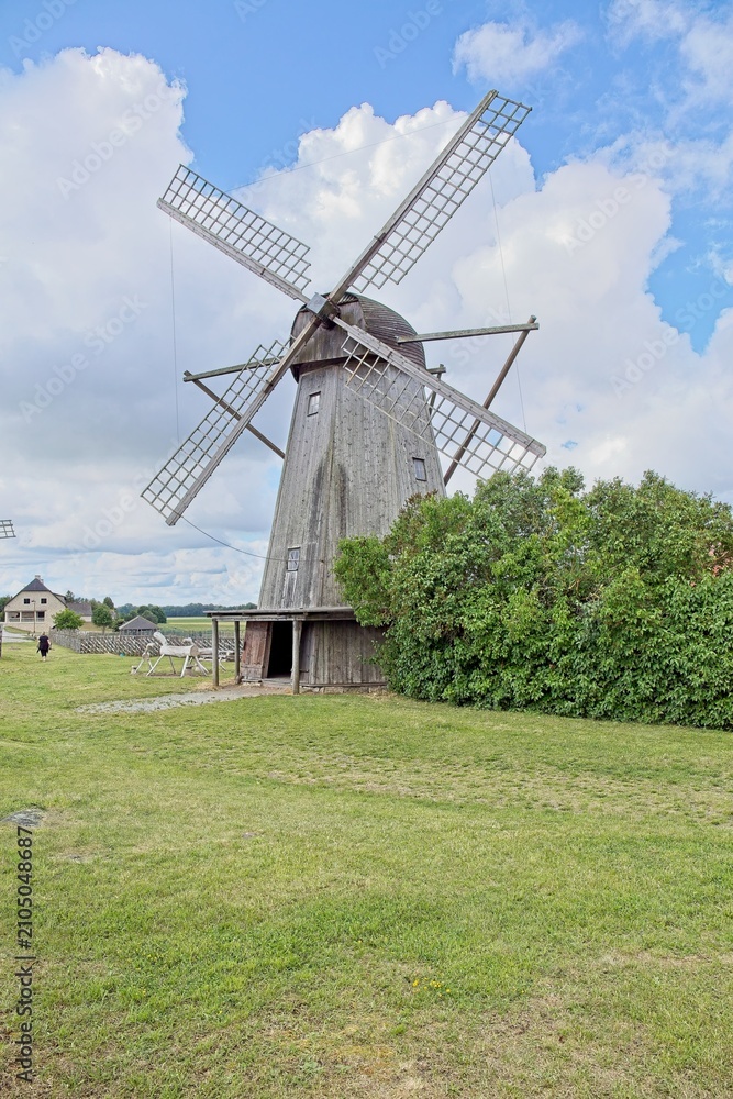 Obraz premium Unique Dutch style wooden windmill built in 1927, located at Angla Windmill Park located on Saaremaa Island in Estonia, Europe.