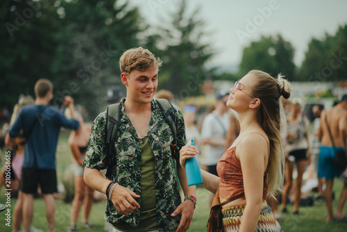 Photography People at summer festival using spray bottle to freshen up.