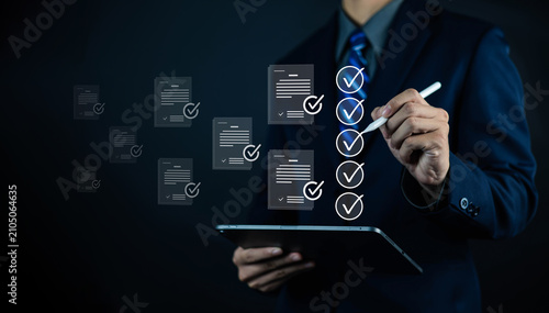 Foto Business professional reviewing digital documents with checklist on tablet, illustrating document verification, compliance audit, quality assurance, workflow management, paperless approval