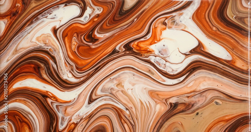 Abstract acrylic pour painting with swirling patterns of burnt orange, dark brown, cream, and tan liquid paint colors