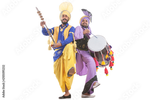 Portrait of Sikh men doing bhangra dance