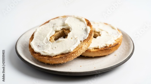 Toasted sesame seed bagel with cream cheese on a plate