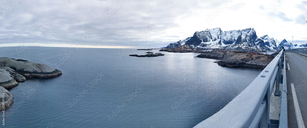 Obraz premium Panoramic Road Trip View from Bridge Over Sea and Snowy Mountains, Lofoten Norway