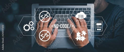 A person using a laptop with no code development tools displayed on the screen showcasing modern technology and user friendly programming solutions for all skill levels.