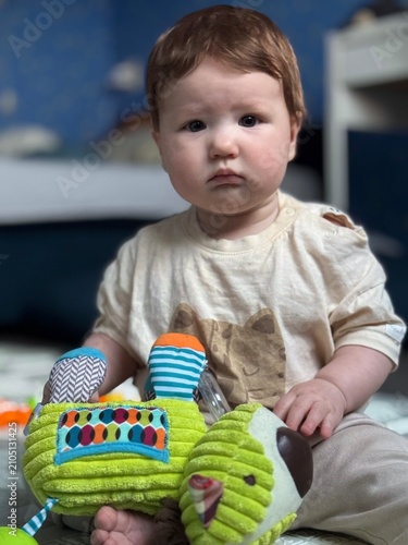 Captivating Candid Moment of a Cute Baby Surrounded by Colorful Toys in a Cozy Environment