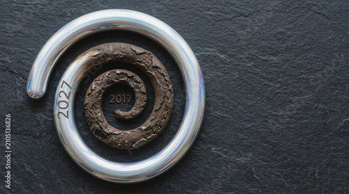 Metallic Spiral Progression Concept Featuring Year Markers on Textured Dark Background