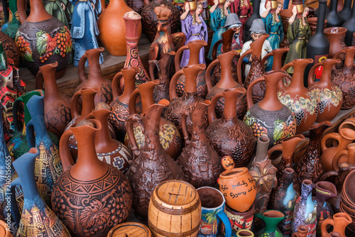 A counter with jugs and ceramic handicrafts made in Georgian national style put up for sale.