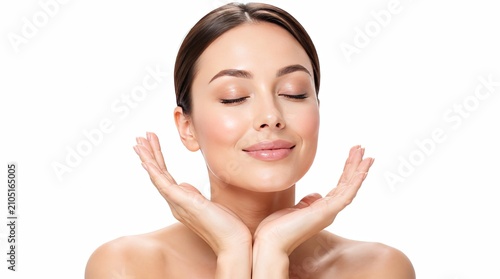 Beautiful young woman with healthy skin touching her face