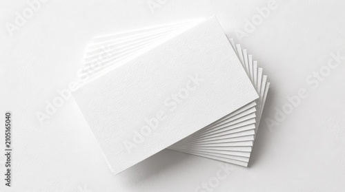 Stack of blank white business cards on textured surface