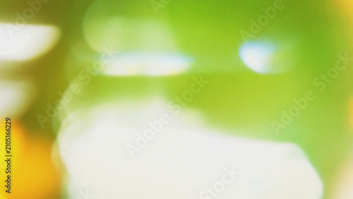 An eye-catching, high-quality background with bright, soft white bokeh shapes over a fresh green texture. Great for eco-friendly concepts, natural lighting effects, and modern banner designs.